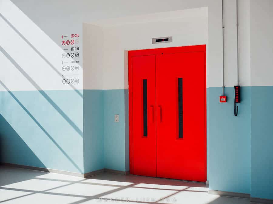 Red door with blue and white wall at Fabrika Hostel in Tbilisi Georgia