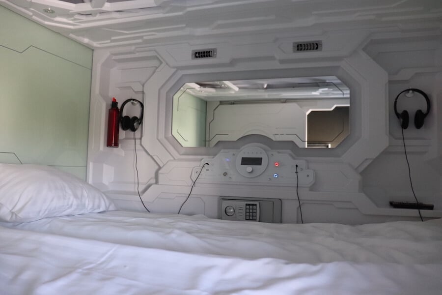 A view inside a sleeping capsule pod at the Galaxy Pod Hostel in Reykjavik Iceland, one of the best hostels in the world for travelers wanting to experience a hostel while still having privacy