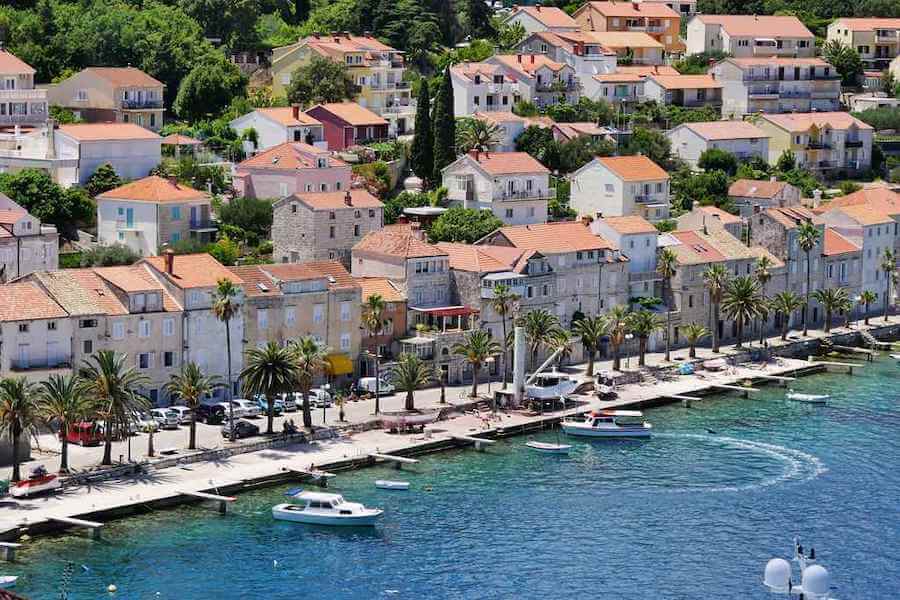 Buildings and the coast on the blue water of the Croatian island Korcula