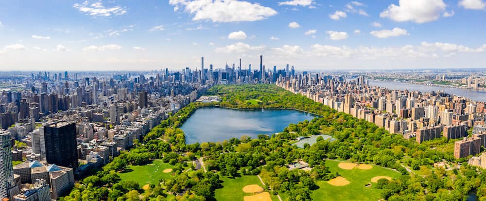 Central Park aerial view, Manhattan, New York. Park is surrounded by skyscraper. Beautiful view of the Jacqueline Kennedy Onassis Reservoir in the center of the park.