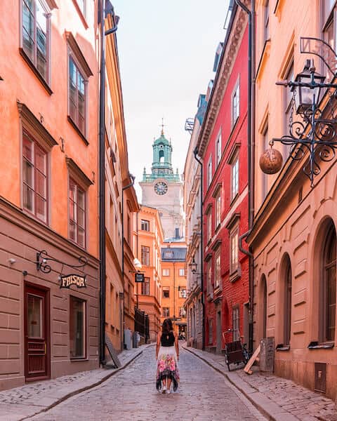 A girl walking through an alley in Gamla Stan, Stockholm